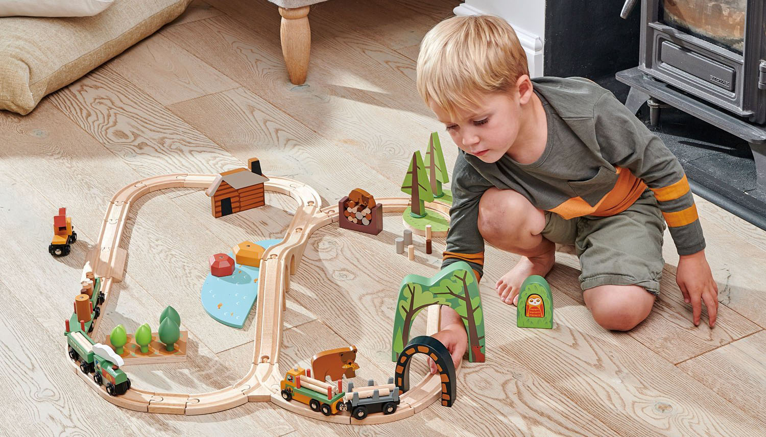 Toddler Boy Playing with Wooden Train Set