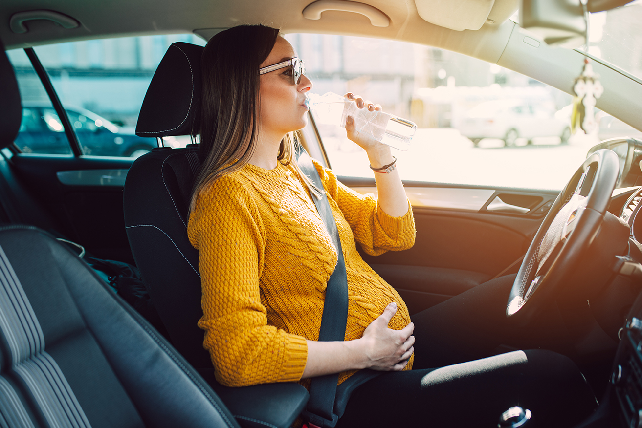 Pregnant Woman in a Car Wearing a Seat Belt